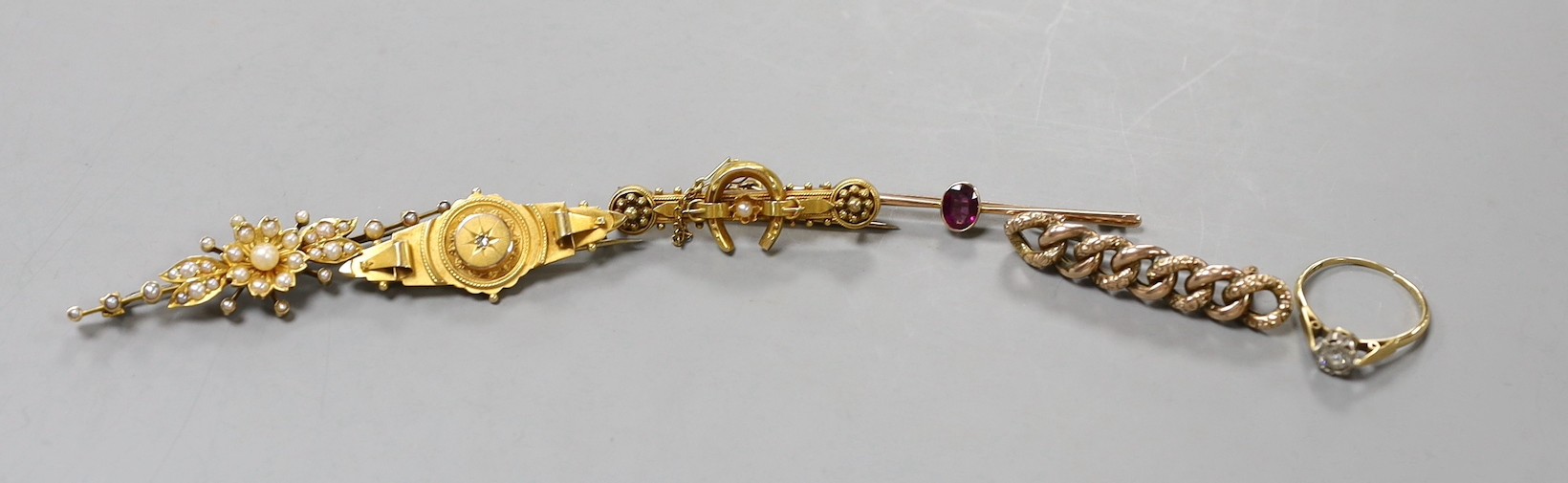 Two early 20th century 9ct and gem set bar brooches, gross weight 4.7 grams, a similar 15ct horseshoe bar brooch, gross 3.4 grams, two other yellow metal and gem set bar brooches, gross 10 grams, a 22ct gold and white op